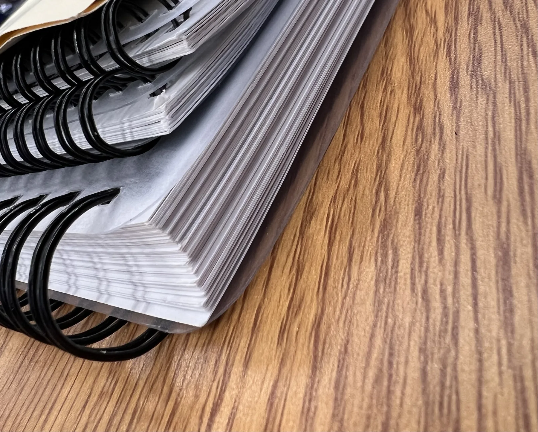 Wire-bound reports stacked on a desk