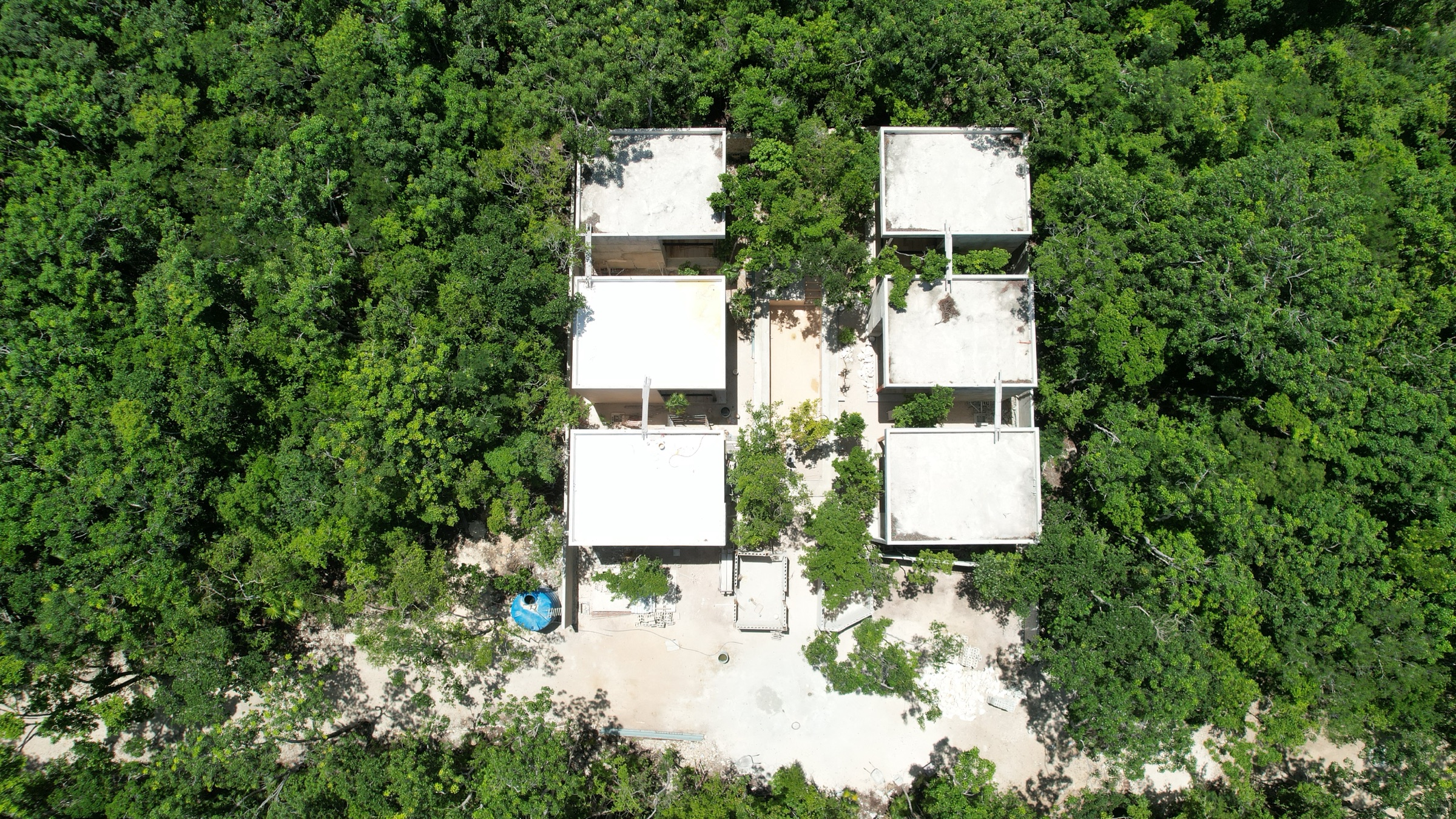 Drone photograph of villa shells under construction on other Axkaba lots