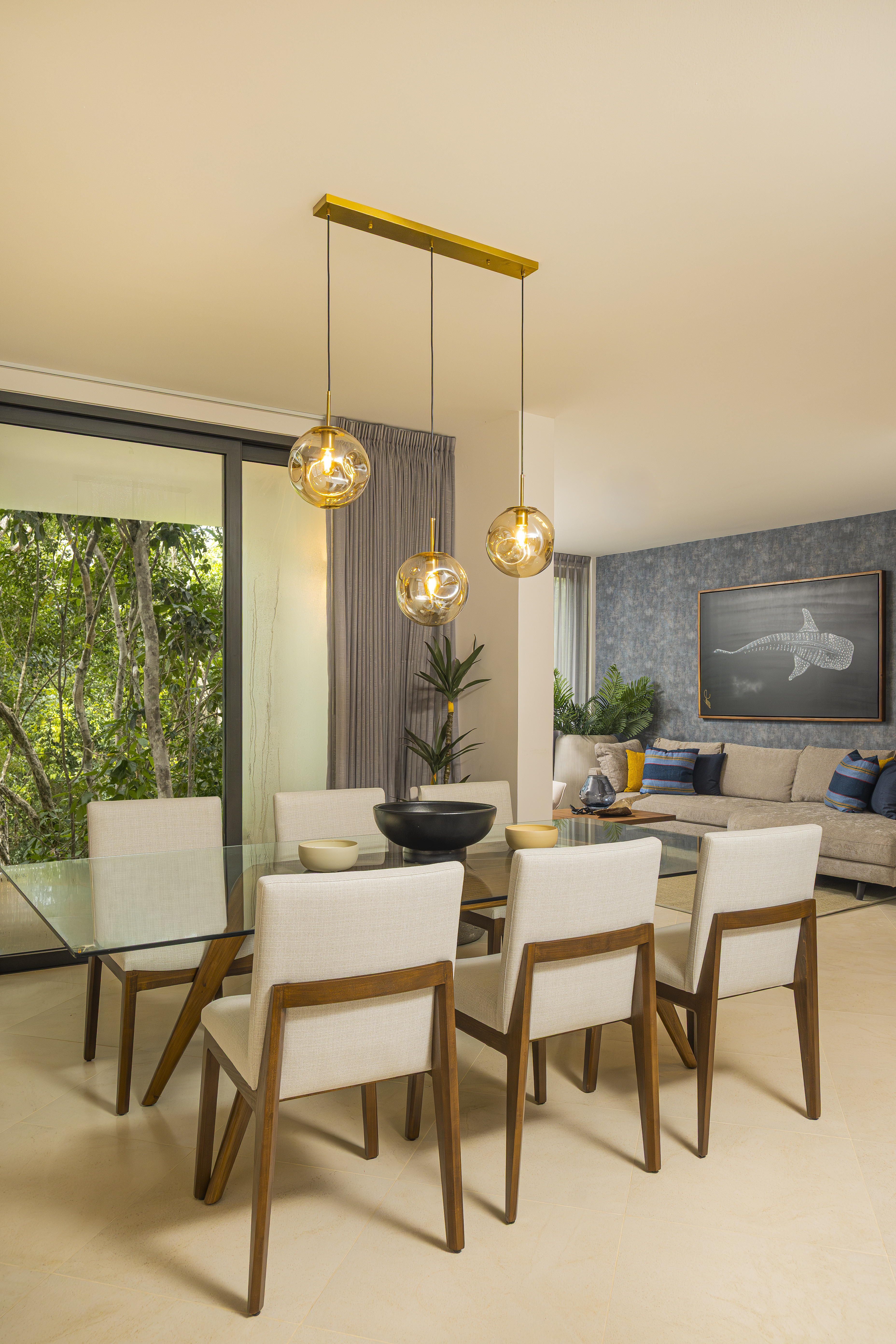 Dining room with pendant chandelier in a styled Bosques Roble unit