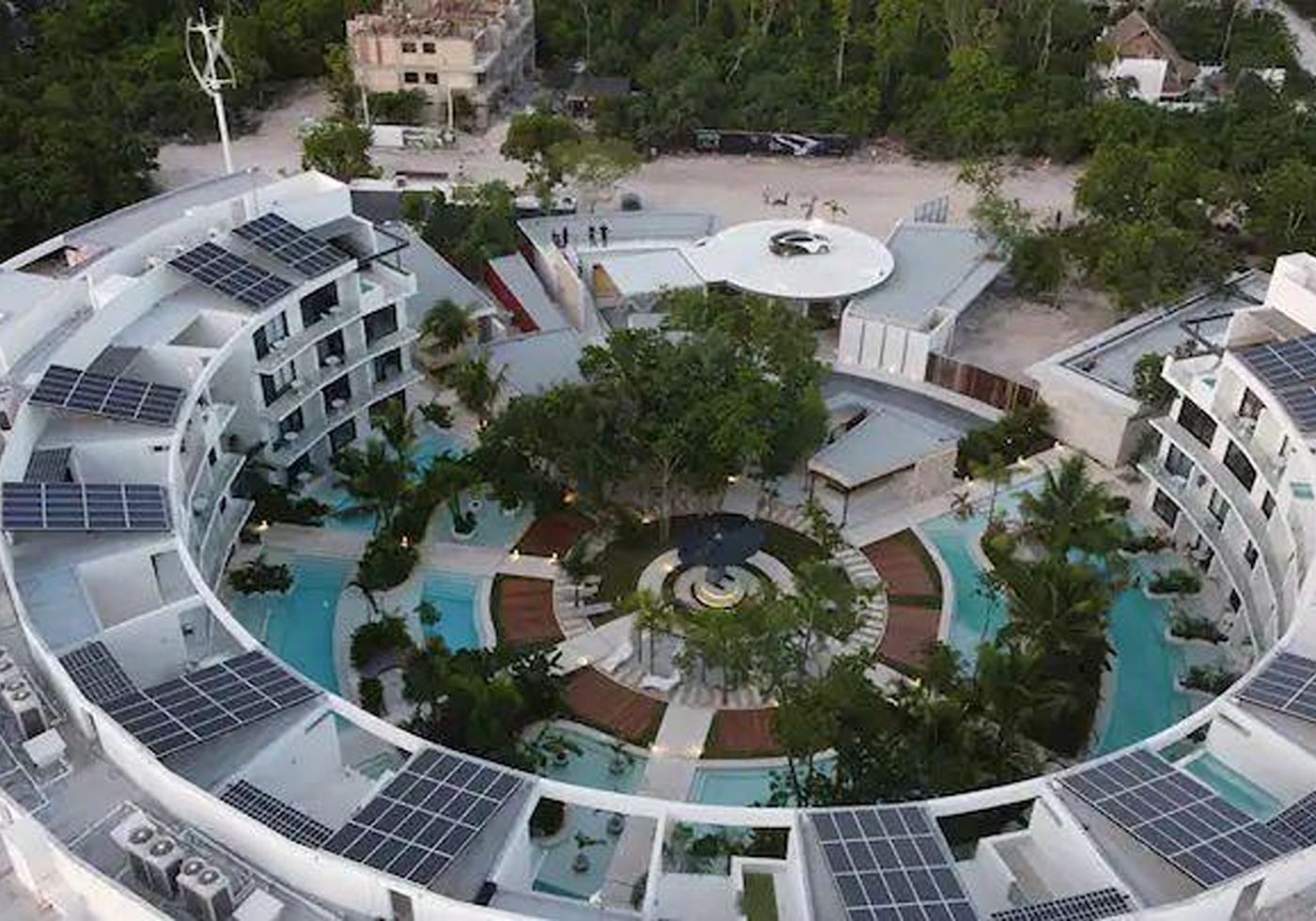 Aerial view of Central Park Lagunas at dusk, with its rooftop passenger-drone landing pad visible