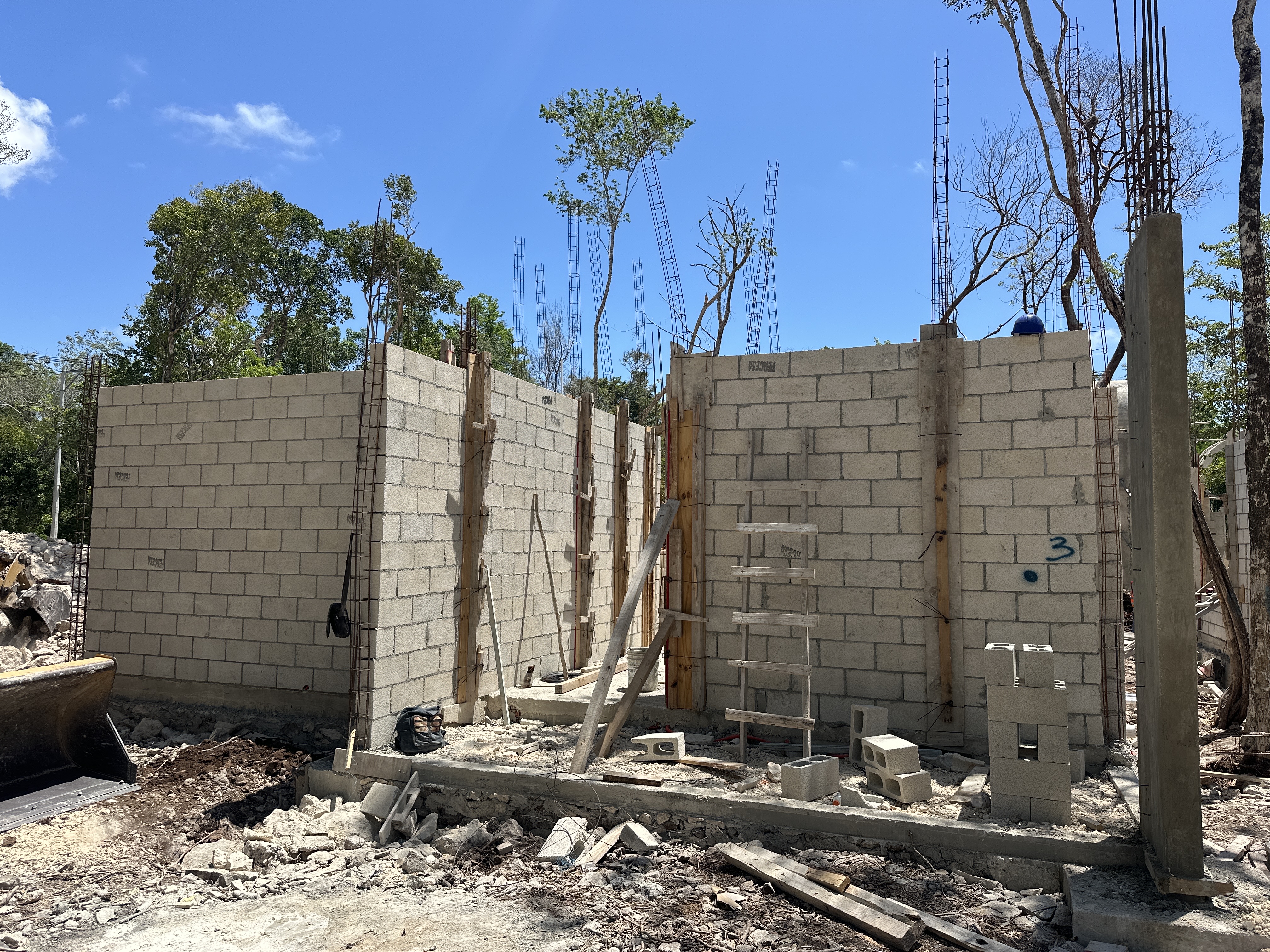 Nonai Villas construction site, cinder-block walls, April 2026