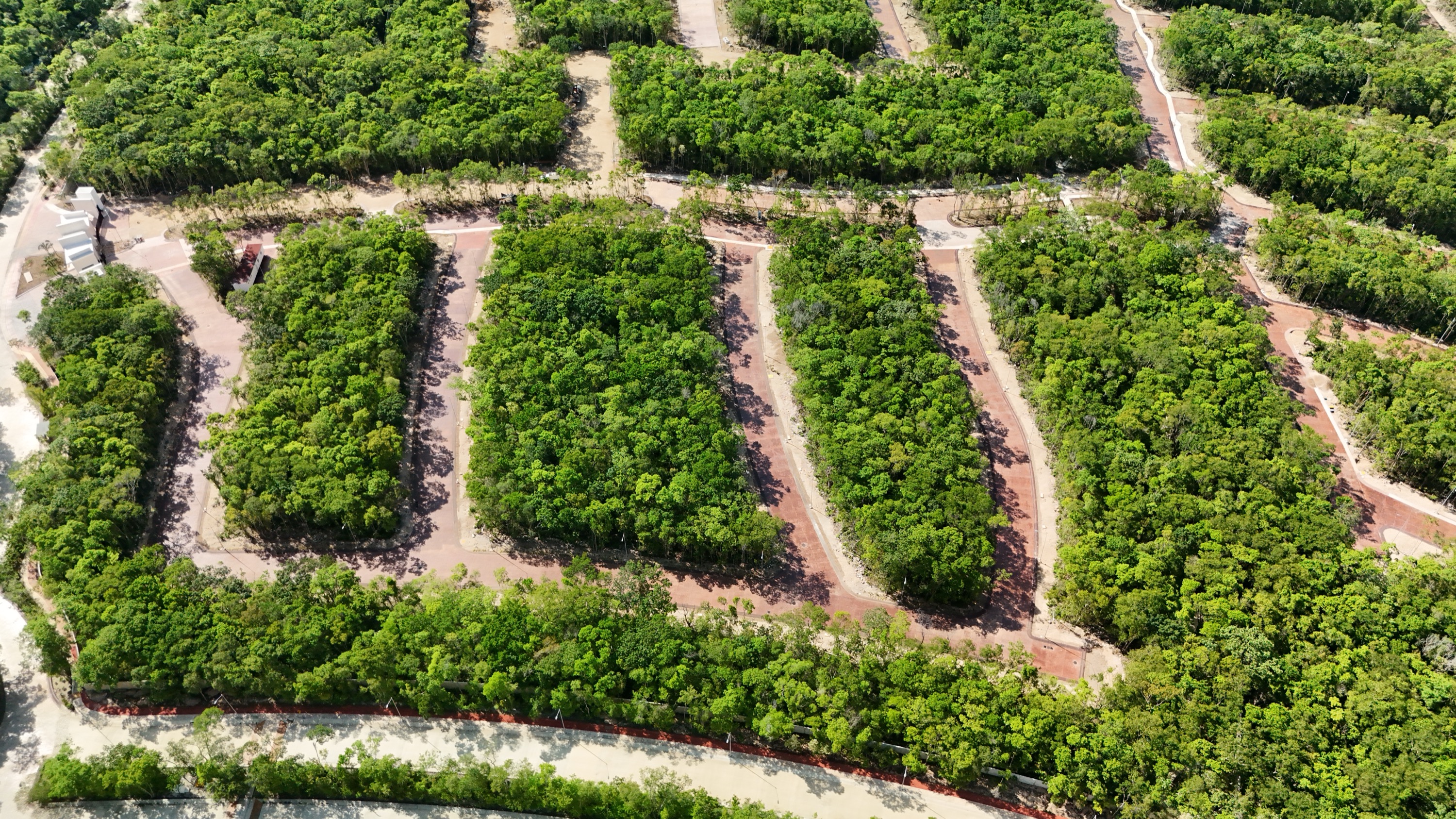 Aerial photograph of platted blocks with finished access roads and no houses built