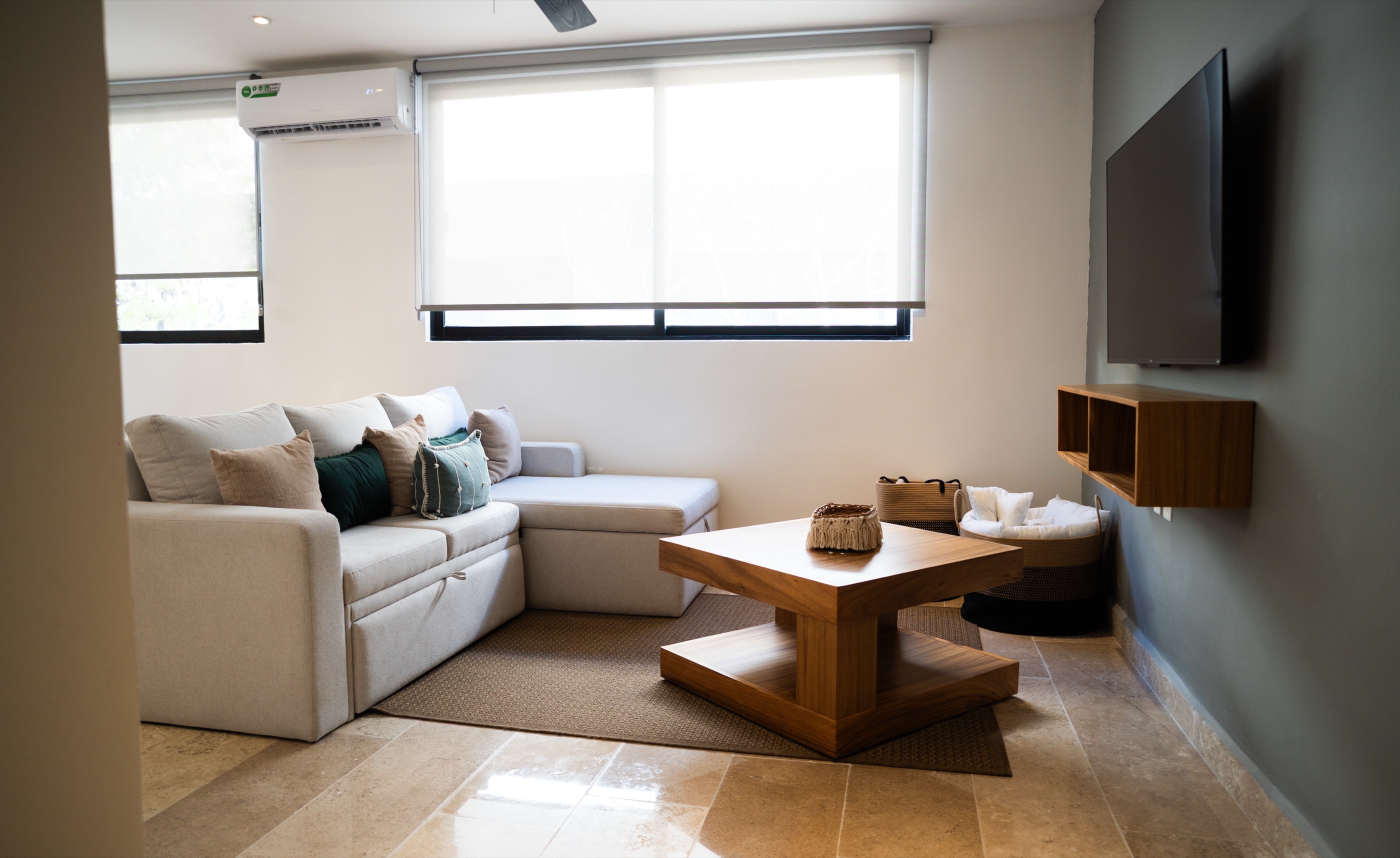 Double-height penthouse living and dining area with staircase