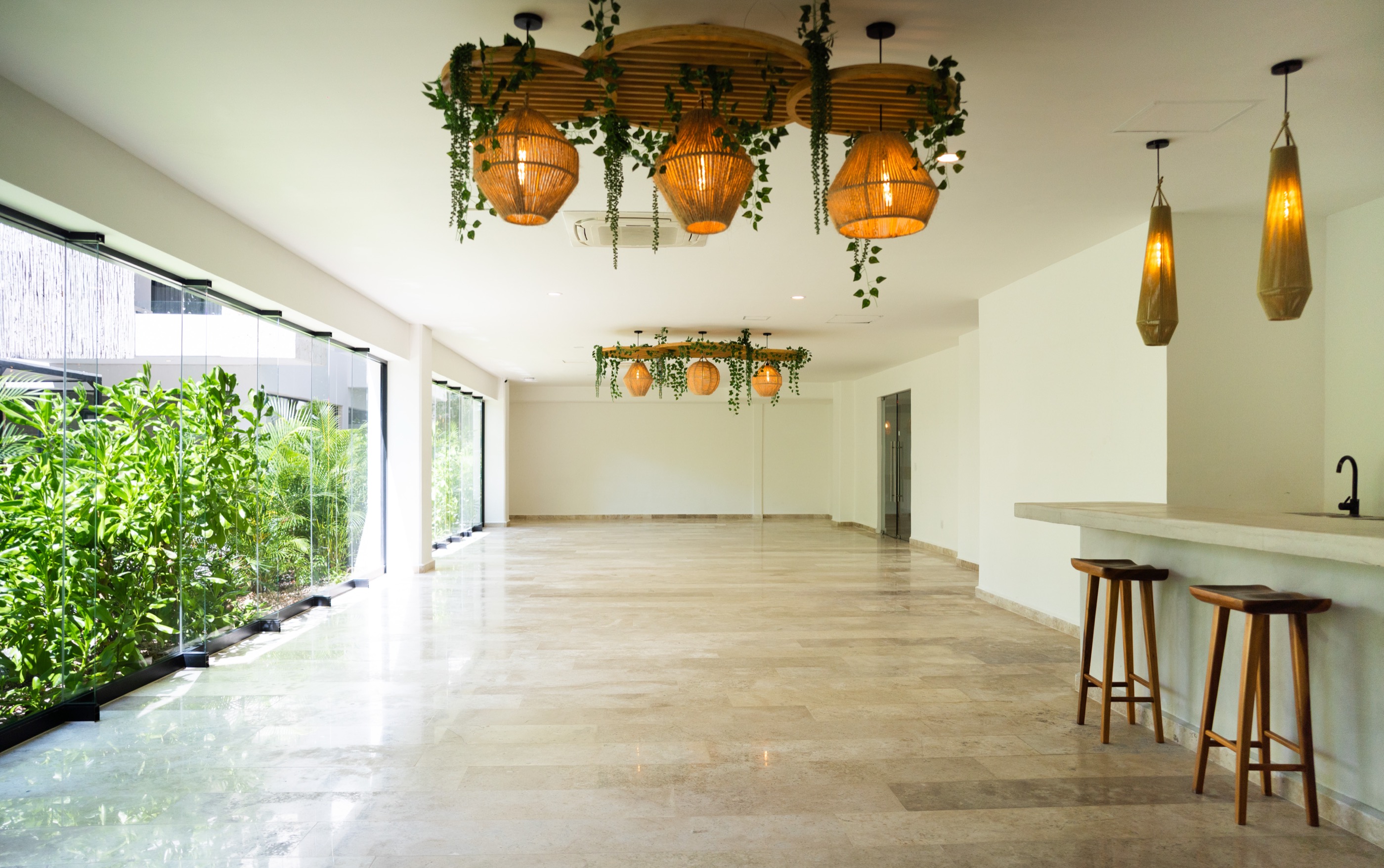 Event hall with bar and pendant lighting, unfurnished