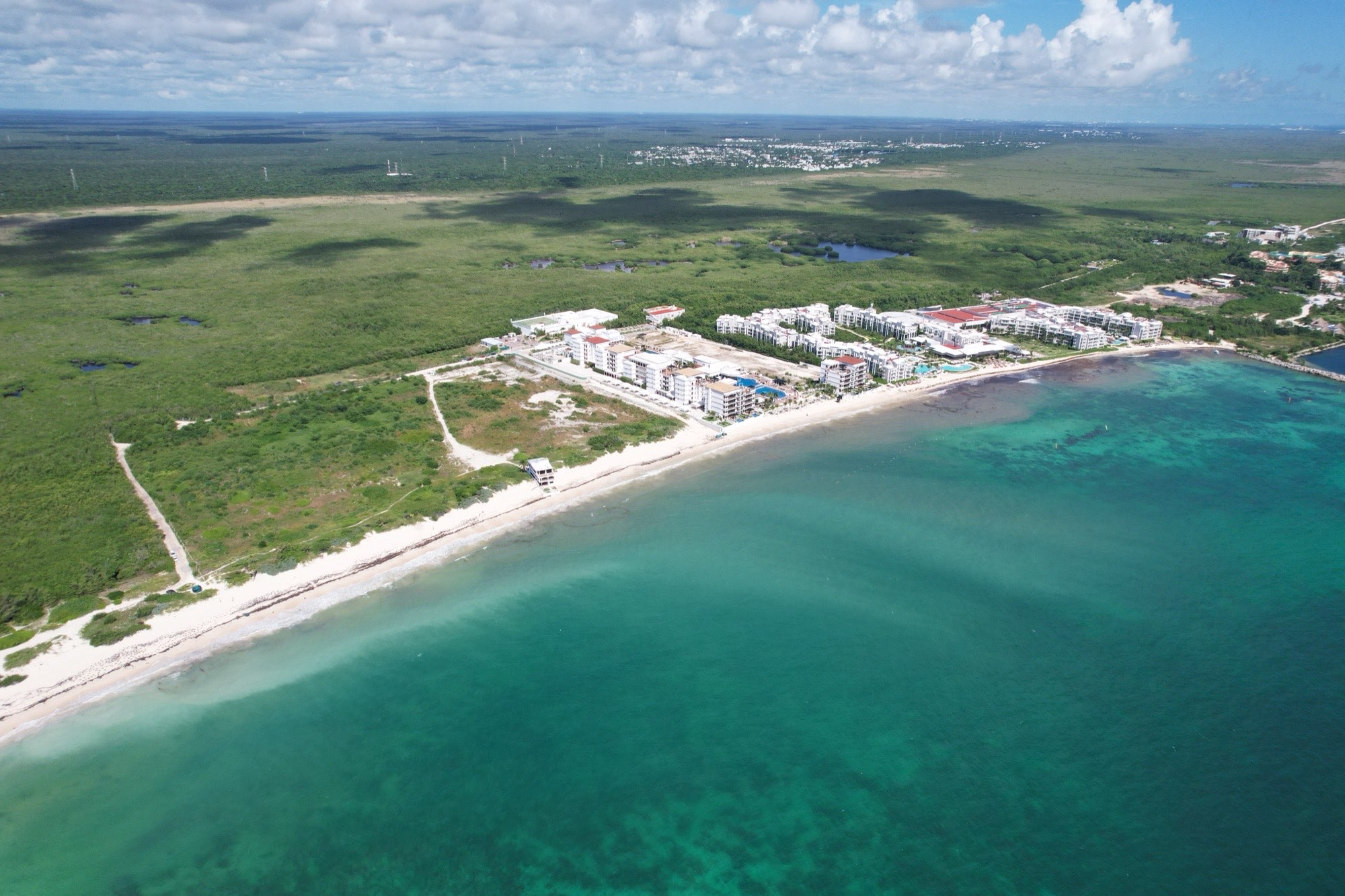 Drone aerial of the raw Puerto Morelos parcel meeting the turquoise Caribbean