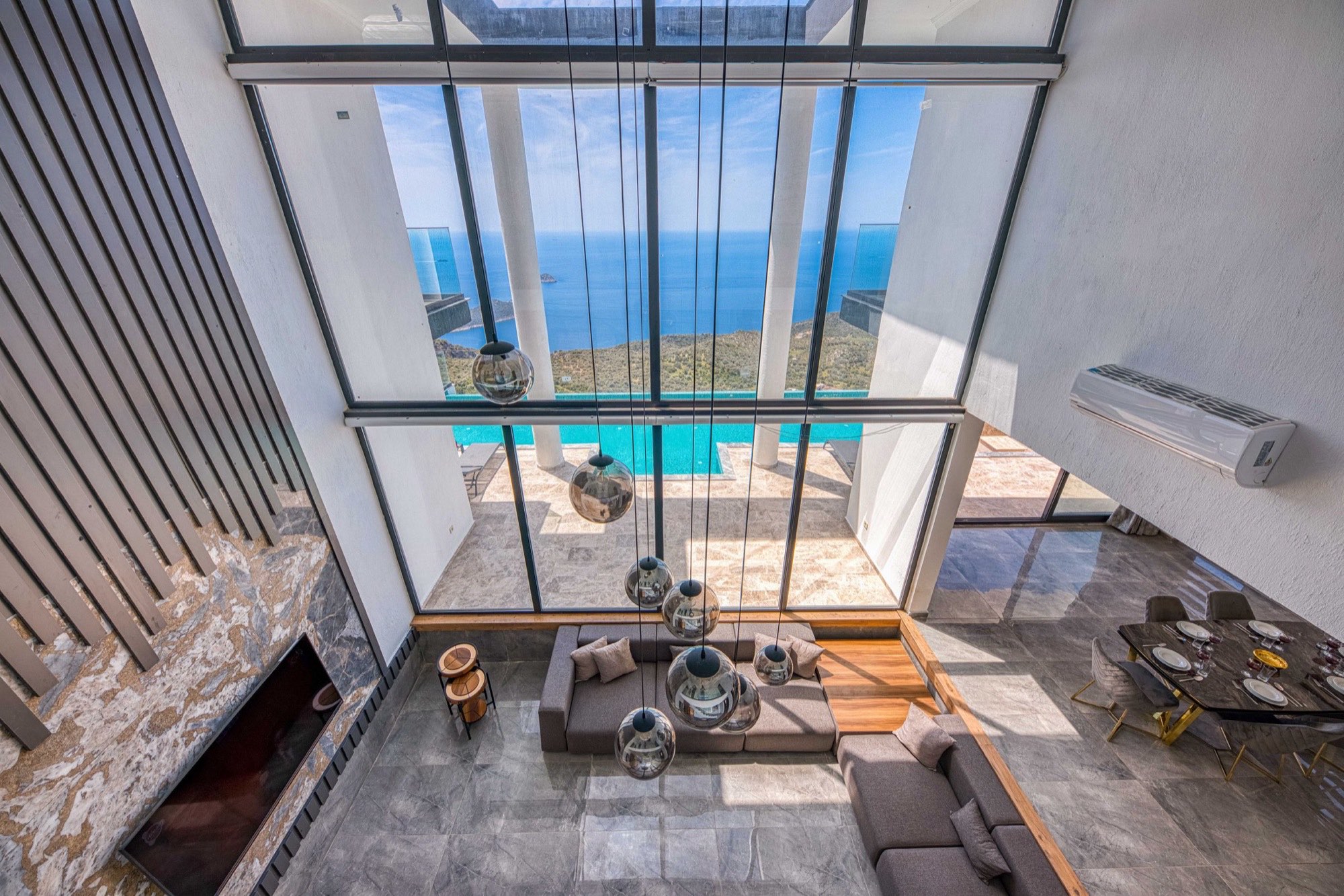 Double-height glass living room over the sea